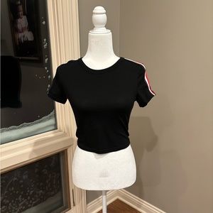 Cute black crop top with red and white stripes on the shoulders.